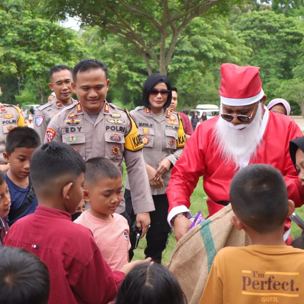 Kapolres Pesawaran Gandeng Sinterklas Sapa Anak-Anak dan Berbagi Jajanan di Wisata Pantai Pesawaran