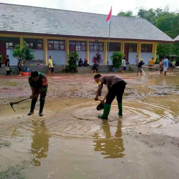 Gotong Royong Polisi dan TNI bersama Warga Bersihkan Sisa Meterial Banjir di Tuban